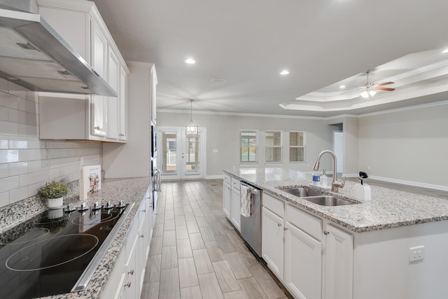 kitchen with wall chimney range hood, sink, dishwasher, white cabinetry, and black electric cooktop