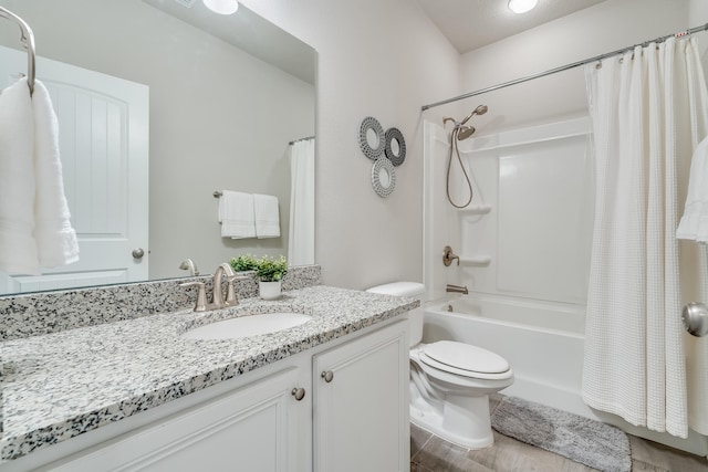 full bathroom with vanity, shower / bath combination with curtain, and toilet