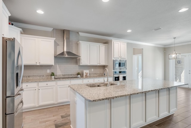 kitchen featuring white cabinetry, appliances with stainless steel finishes, sink, and wall chimney range hood