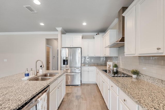 kitchen featuring stainless steel appliances, white cabinetry, light stone countertops, and wall chimney exhaust hood