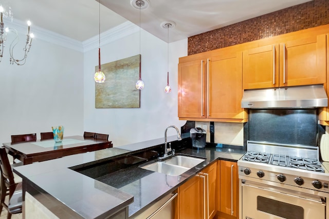 kitchen featuring sink, dark stone counters, hanging light fixtures, designer stove, and crown molding