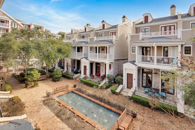 back of property featuring pool water feature