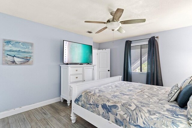 bedroom with hardwood / wood-style floors and ceiling fan