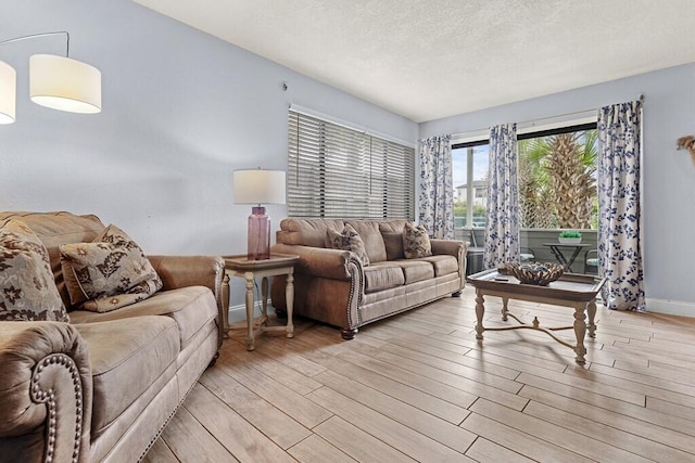 living room featuring a textured ceiling and light hardwood / wood-style flooring