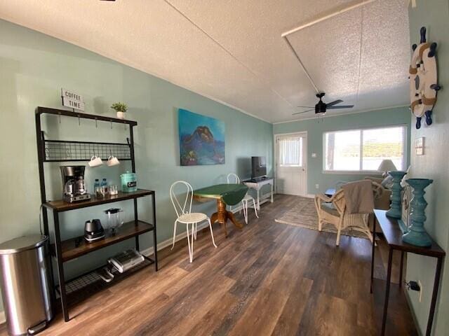 living area with hardwood / wood-style floors, a textured ceiling, and ceiling fan