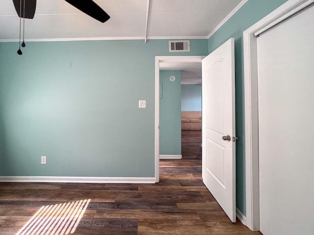 spare room featuring crown molding, dark hardwood / wood-style floors, and ceiling fan