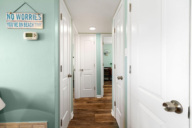 corridor featuring dark wood-type flooring