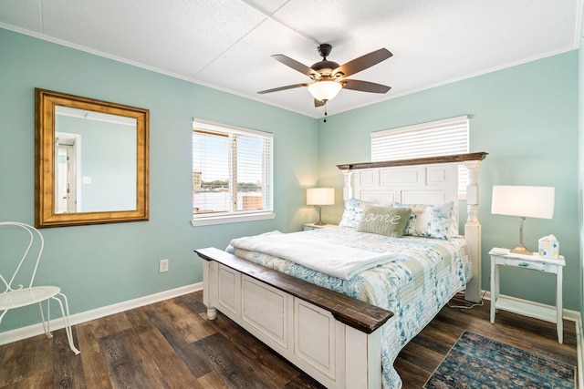 bedroom featuring baseboards, crown molding, dark wood-style flooring, and a ceiling fan