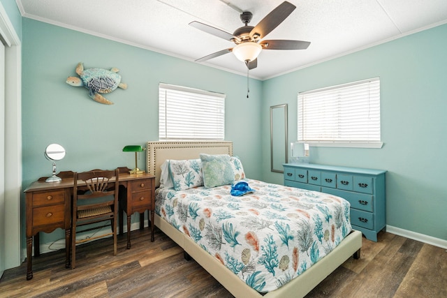 bedroom with dark wood finished floors, crown molding, baseboards, and a ceiling fan