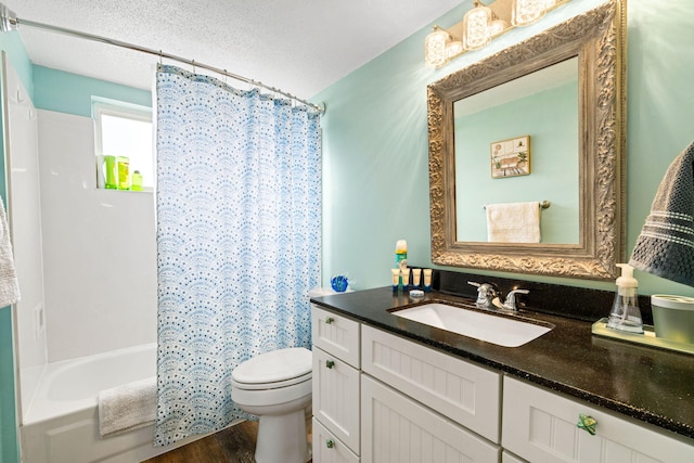 full bathroom with toilet, wood finished floors, vanity, shower / bath combination with curtain, and a textured ceiling