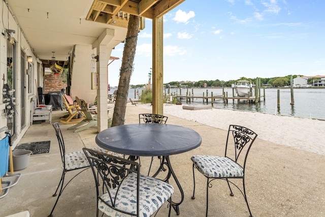 view of patio / terrace featuring a boat dock, a water view, and boat lift