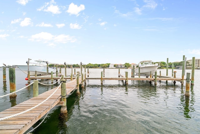 dock area with boat lift and a water view