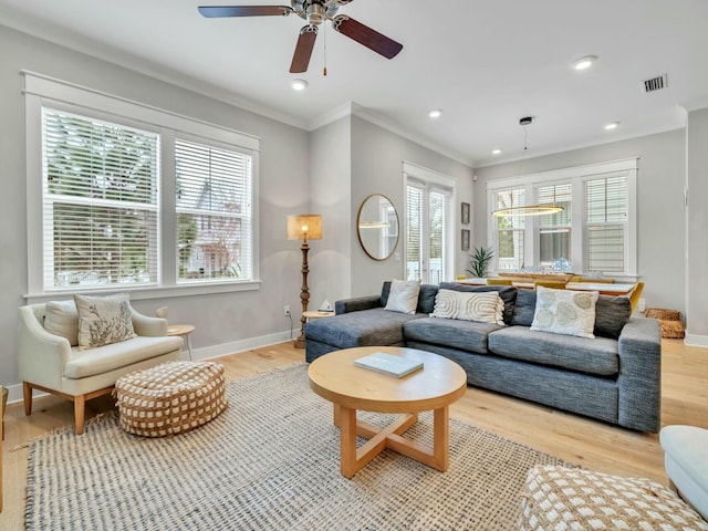 living area with recessed lighting, crown molding, light wood-style flooring, and baseboards