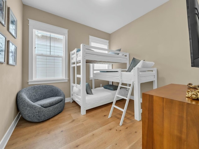 bedroom with light wood-style flooring and baseboards