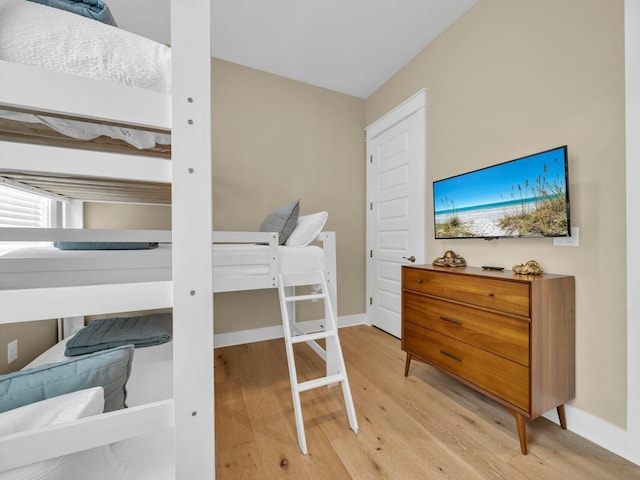 bedroom with light wood-style floors and baseboards