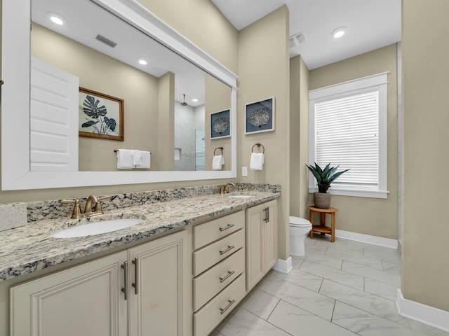 bathroom with marble finish floor, double vanity, a sink, and visible vents