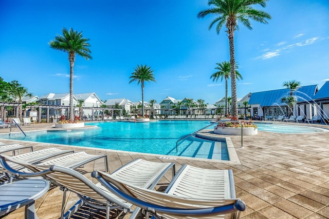 community pool featuring a patio area and a residential view