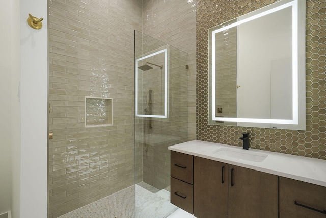 bathroom featuring vanity and tiled shower