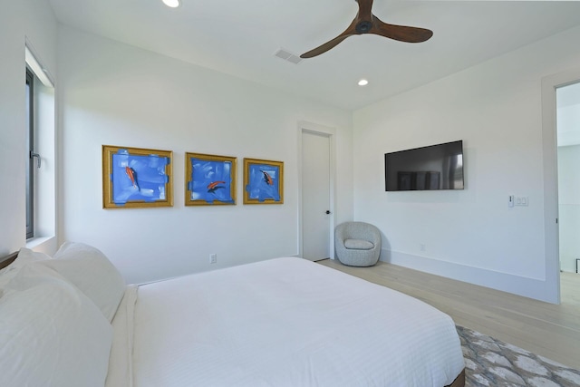 bedroom with ceiling fan and light wood-type flooring