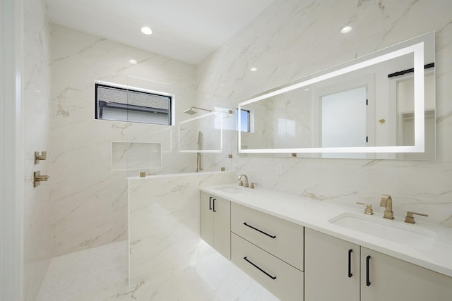 bathroom featuring vanity, decorative backsplash, tile walls, and tiled shower