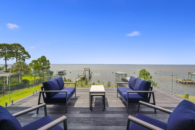 wooden deck with an outdoor living space and a water view