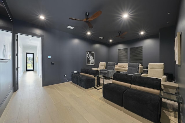 cinema featuring ceiling fan and light wood-type flooring