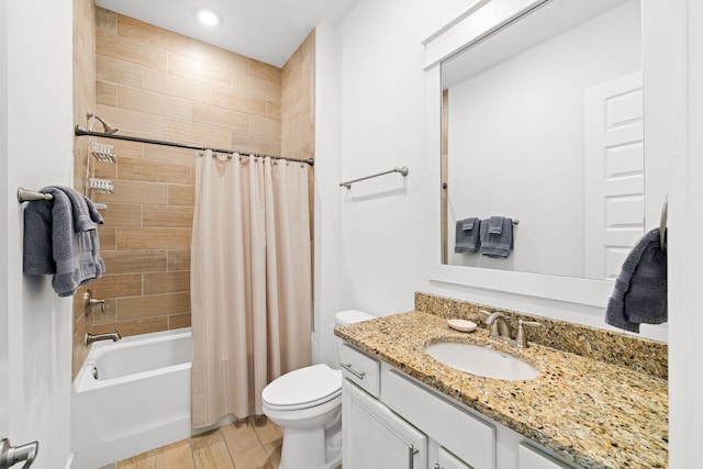 full bathroom with vanity, wood-type flooring, toilet, and shower / bath combo with shower curtain