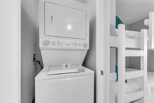 washroom with stacked washer and dryer