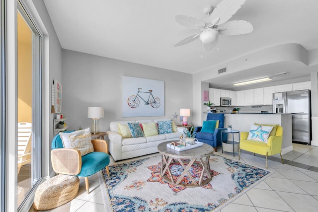 tiled living room featuring ceiling fan