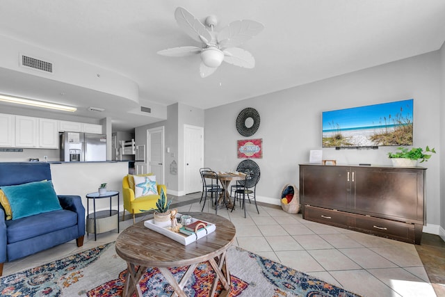 tiled living room featuring ceiling fan