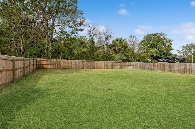 view of yard with a fenced backyard