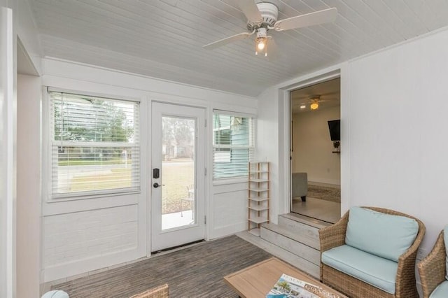 doorway featuring a ceiling fan, a wealth of natural light, and wooden ceiling