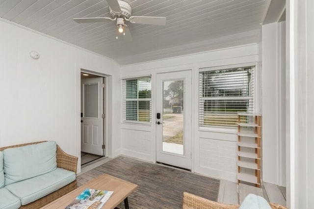 entryway with a ceiling fan, dark wood-type flooring, and crown molding