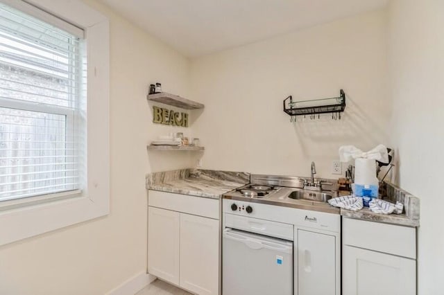 kitchen featuring baseboards, white cabinetry, open shelves, and a sink