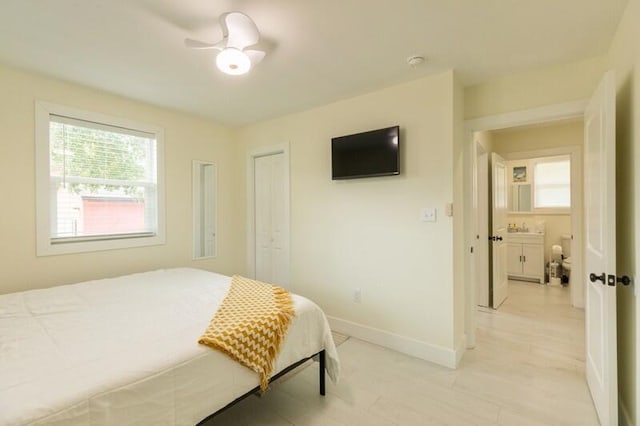 bedroom featuring baseboards and a closet