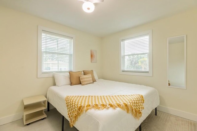 bedroom with multiple windows and baseboards