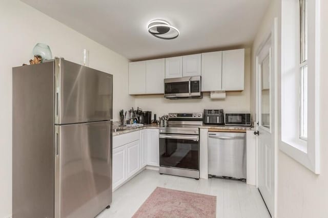 kitchen featuring white cabinetry and appliances with stainless steel finishes