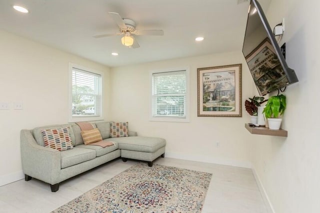 living area with recessed lighting, a ceiling fan, and baseboards