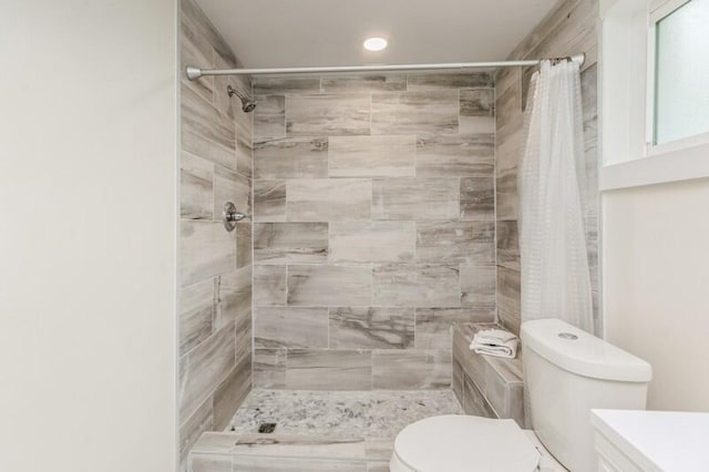 bathroom featuring a stall shower, vanity, and toilet