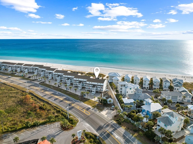 drone / aerial view featuring a water view and a beach view