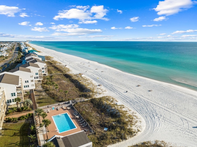 drone / aerial view featuring a water view and a beach view