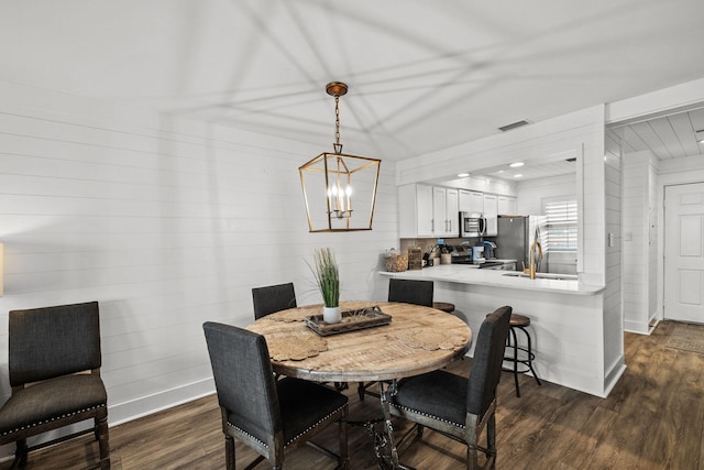 dining room with dark hardwood / wood-style flooring