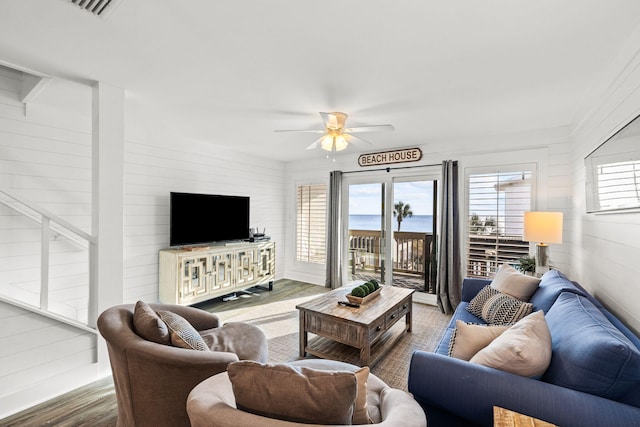 living room featuring hardwood / wood-style flooring and ceiling fan