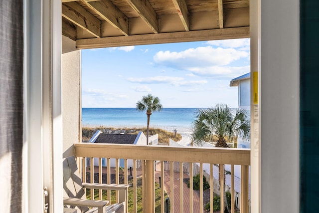 balcony with a water view and a beach view