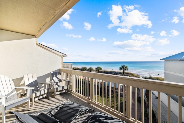 balcony featuring a beach view and a water view