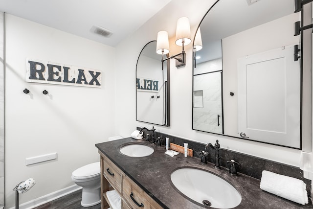 23011 Front Beach Rd Unit 65, Panama City Beach, FL 32413 - full bathroom featuring double vanity, toilet, a shower, and baseboards