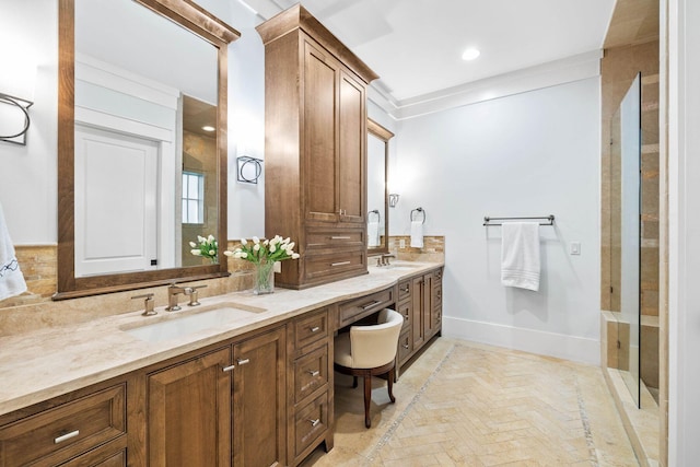 full bathroom with double vanity, baseboards, a sink, and recessed lighting