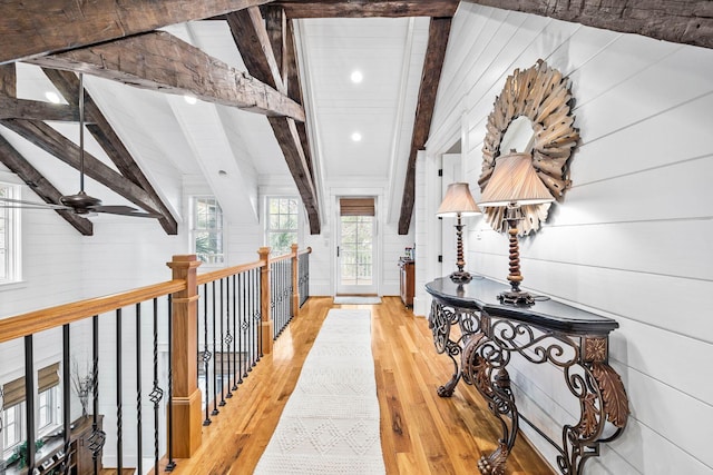 hall featuring vaulted ceiling with beams and wood finished floors