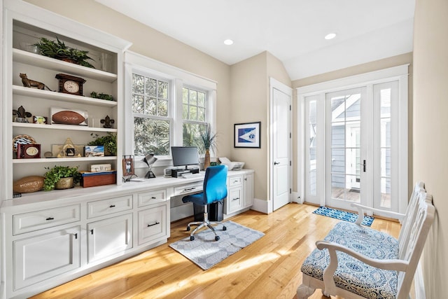 office space featuring light wood-style floors, recessed lighting, lofted ceiling, and baseboards