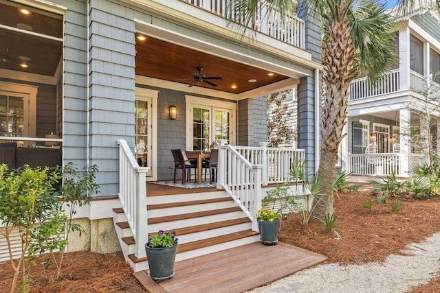 property entrance featuring ceiling fan, covered porch, and a balcony